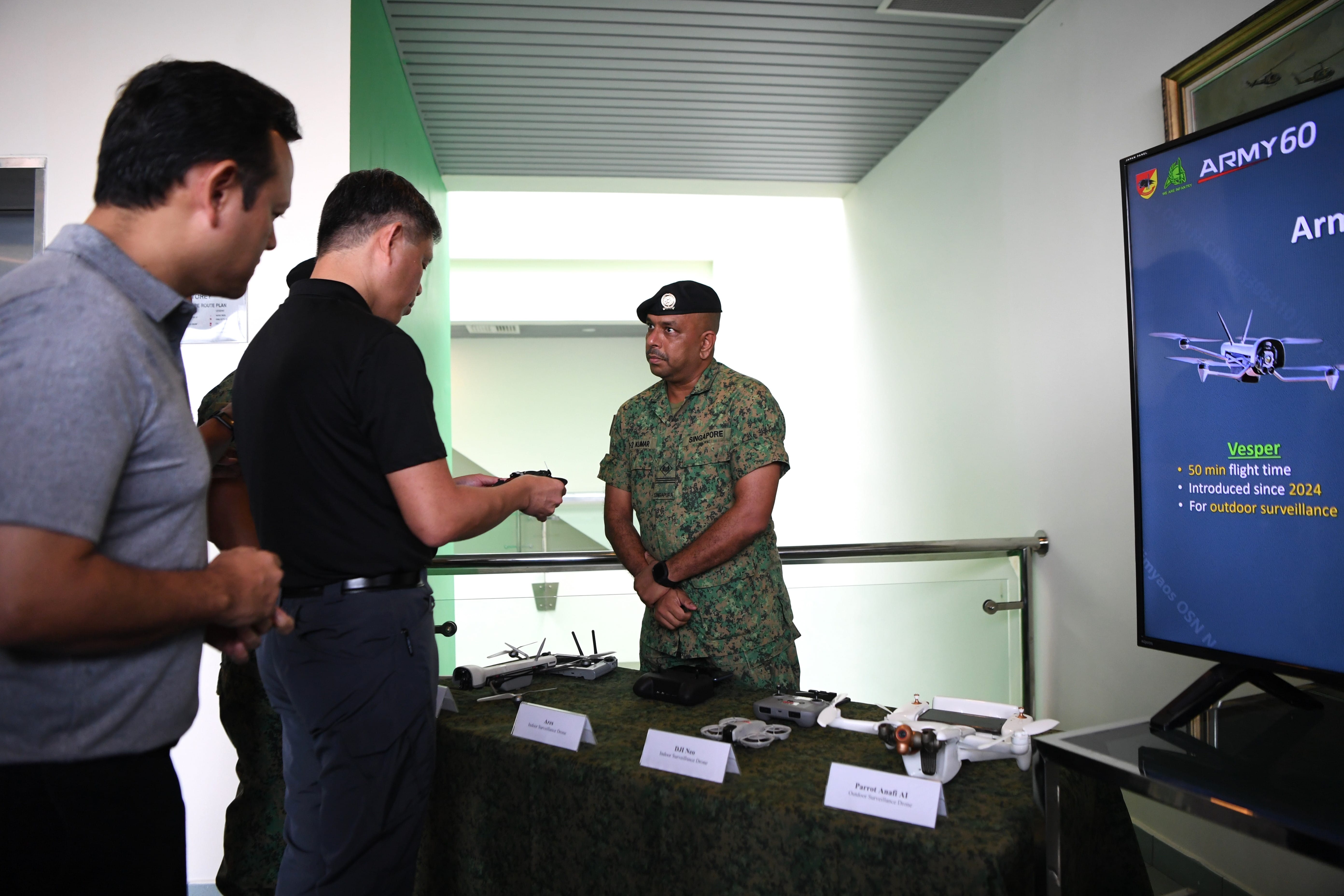 Mr Chan viewing a suite of drone displays at the Basic Military Training Centre (BMTC).